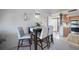 Cozy dining area with table and four chairs, near the kitchen in a neutral color palette at 311 Garvin St # 209C, Punta Gorda, FL 33950