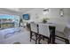 Dining area with table and four chairs next to the living room and balcony access at 311 Garvin St # 209C, Punta Gorda, FL 33950