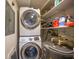 Efficient laundry area with stacked washer/dryer and shelving for storage solutions at 311 Garvin St # 209C, Punta Gorda, FL 33950