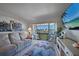 Cozy living room with a balcony offering waterfront views and comfortable furnishings at 311 Garvin St # 209C, Punta Gorda, FL 33950