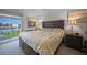 This primary bedroom offers neutral decor, including carpeting and access to a private lanai at 311 Garvin St # 209C, Punta Gorda, FL 33950
