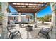 Outdoor retreat showcasing a cozy fire pit and lounge beneath a pergola, steps away from a beach setting at 4078 N Beach Rd, Englewood, FL 34223