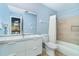 Modern bathroom showcasing a sleek vanity, a large mirror, and a shower with neutral tile surround at 4078 N Beach Rd, Englewood, FL 34223