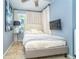 Comfortable bedroom showcasing a plush bed, soft lighting, and a wall-mounted television for entertainment at 4078 N Beach Rd, Englewood, FL 34223