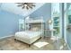 Bright bedroom offering a lofted bed, high ceilings, and large windows for scenic outdoor views at 4078 N Beach Rd, Englewood, FL 34223