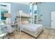 Spacious bedroom featuring a lofted bed, a cozy workspace, and large windows that let in natural light at 4078 N Beach Rd, Englewood, FL 34223