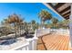 Wooden deck with white railing overlooking the beach at 4078 N Beach Rd, Englewood, FL 34223