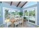 Bright dining area with views of the outdoor deck and lush greenery at 4078 N Beach Rd, Englewood, FL 34223