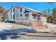 Charming coastal home featuring a spacious deck, modern design, and white picket fence at 4078 N Beach Rd, Englewood, FL 34223