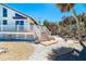 Exterior of beach home showing deck, stairs, landscaping and home's facade at 4078 N Beach Rd, Englewood, FL 34223