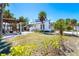 View of home exterior with pergola and fire pit in the backyard at 4078 N Beach Rd, Englewood, FL 34223