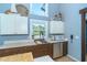 Contemporary kitchen with stainless steel appliances, wood cabinets, and a practical layout at 4078 N Beach Rd, Englewood, FL 34223