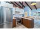 Bright kitchen with vaulted wood ceilings, stainless appliances, and island with seating at 4078 N Beach Rd, Englewood, FL 34223