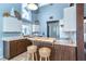 Stylish kitchen featuring two-tone cabinets, breakfast bar, and modern appliances at 4078 N Beach Rd, Englewood, FL 34223