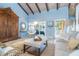 Bright living room with vaulted ceilings, wooden beams, and an inviting seating area at 4078 N Beach Rd, Englewood, FL 34223