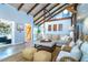Bright living room with vaulted ceilings, wooden beams, and a comfortable seating area at 4078 N Beach Rd, Englewood, FL 34223