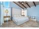 Inviting main bedroom with king bed, wood ceiling beams, and natural light at 4078 N Beach Rd, Englewood, FL 34223
