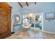 Relaxing sitting area with stylish hanging chair, natural light, and tile floors at 4078 N Beach Rd, Englewood, FL 34223