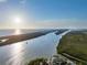 Wide aerial view of the riverfront estate community, showcasing access to the ocean with views of multiple houses at 425 Spaniards Rd, Placida, FL 33946