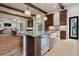 Open-concept kitchen with a large island, farmhouse sink, pendant lighting and stainless steel appliances at 425 Spaniards Rd, Placida, FL 33946
