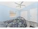 Cozy bedroom with a wrought iron bed frame, ample natural light, ceiling fan, and closet at 431 Rotonda Cir, Rotonda West, FL 33947