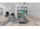Open living space featuring wood-look floors, a ceiling fan, and sliding glass doors to lanai at 431 Rotonda Cir, Rotonda West, FL 33947