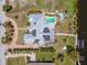 Overhead view of a home featuring a pool, hot tub, solar panels, canal access, and tropical landscaping at 50 Spyglass Aly, Placida, FL 33946