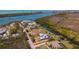 Wide aerial view showcasing the neighborhood, nearby waterway, and the home's proximity to local amenities at 50 Spyglass Aly, Placida, FL 33946