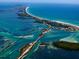 Breathtaking aerial view showcases the coastal community, sparkling turquoise waters, and pristine sandy beaches at 50 Spyglass Aly, Placida, FL 33946
