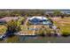 Aerial view of the backyard featuring a pool, dock, and beautiful landscaping, perfect for outdoor entertaining at 50 Spyglass Aly, Placida, FL 33946