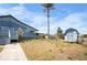 Backyard with a small storage house and expansive porch featuring large windows in a serene residential setting at 50 Spyglass Aly, Placida, FL 33946