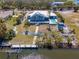 Aerial view of the backyard featuring a pool, dock, and beautiful landscaping, perfect for outdoor entertaining at 50 Spyglass Aly, Placida, FL 33946