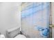 Bathroom with new low-flow toilet and coastal themed shower curtain at 50 Spyglass Aly, Placida, FL 33946