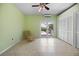 Bright bedroom featuring tile flooring, a ceiling fan, and access to a private balcony with a view at 50 Spyglass Aly, Placida, FL 33946