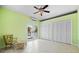 Bright bedroom with tile flooring, ceiling fan, closet, and access to the balcony via glass doors at 50 Spyglass Aly, Placida, FL 33946