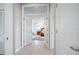 Hallway leading to bedroom with double doors and tile flooring at 50 Spyglass Aly, Placida, FL 33946