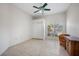 Bright bedroom boasts tile floors, ceiling fan, window shutters, and closet at 50 Spyglass Aly, Placida, FL 33946
