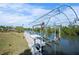 Private boat lift on a tranquil canal, offering easy access to the water for boating and recreation at 50 Spyglass Aly, Placida, FL 33946