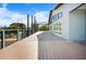 Expansive outdoor deck with black metal railings and an adjacent powder blue home, perfect for entertaining or relaxing at 50 Spyglass Aly, Placida, FL 33946