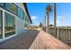 Powder blue house features a spacious outdoor deck, complete with modern railings and large windows for natural light at 50 Spyglass Aly, Placida, FL 33946
