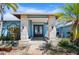 The home's front porch with brick support columns and decorative double doors at 50 Spyglass Aly, Placida, FL 33946