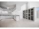 Open concept kitchen with granite counters, white cabinets, and tiled floors at 50 Spyglass Aly, Placida, FL 33946