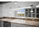 Open kitchen featuring granite countertops, breakfast bar, and views into the living area at 50 Spyglass Aly, Placida, FL 33946