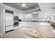 Modern kitchen with granite countertops, white cabinets, and stainless steel appliances at 50 Spyglass Aly, Placida, FL 33946