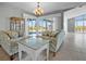 Living room with floral sofas, large windows, and an elegant chandelier at 50 Spyglass Aly, Placida, FL 33946