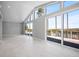 Bright living room features tile floors, large windows, and a sliding glass door to the patio at 50 Spyglass Aly, Placida, FL 33946