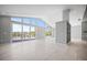 Spacious living room with tile flooring, large windows, and access to the outdoor deck at 50 Spyglass Aly, Placida, FL 33946