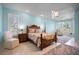 Spacious main bedroom boasts custom bed frame, natural light, and soft blue walls at 50 Spyglass Aly, Placida, FL 33946