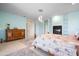 Spacious main bedroom boasts custom bed frame, natural light, fireplace and soft blue walls at 50 Spyglass Aly, Placida, FL 33946