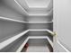 Walk-in pantry with painted shelving and tile flooring at 50 Spyglass Aly, Placida, FL 33946